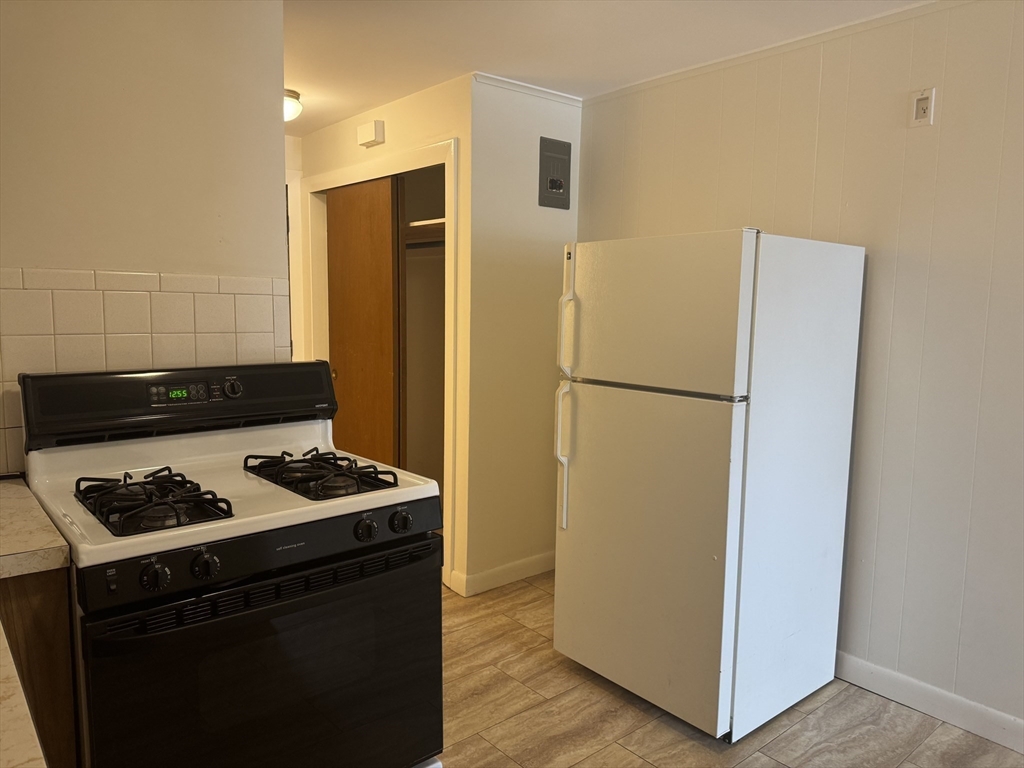 100 Magnolia Avenue, Unit 4 Lynn, MA 01904 - Photo 13 of 19 a kitchen with a refrigerator and a stove top oven