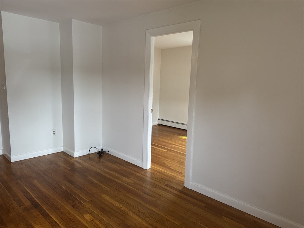 100 Magnolia Avenue, Unit 4 Lynn, MA 01904 - Photo 16 of 19 a view of empty room with wooden floor