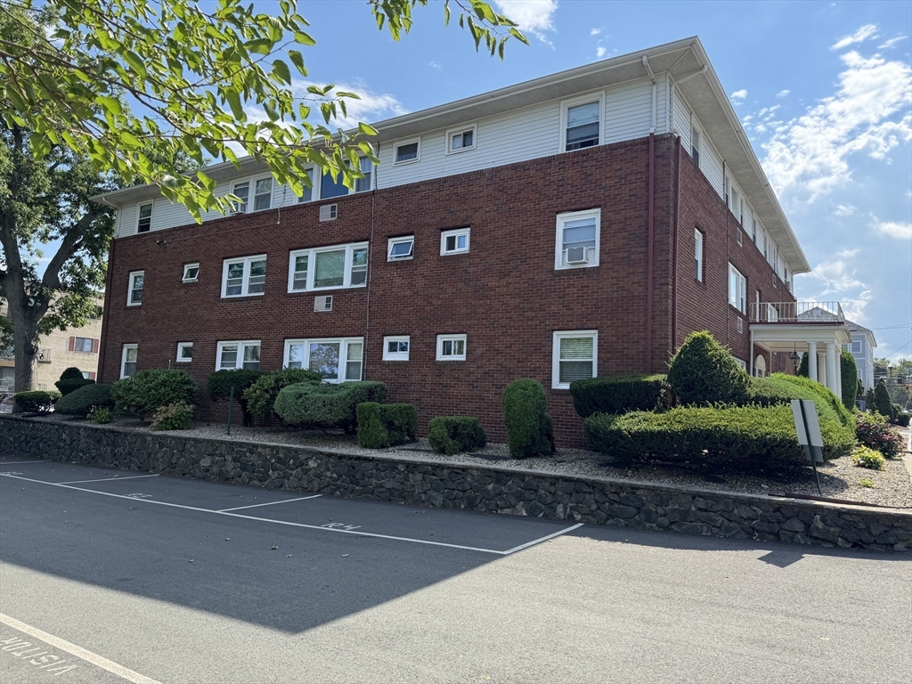 100 Magnolia Avenue, Unit 4 Lynn, MA 01904 - Photo 3 of 19 a front view of a house with a yard