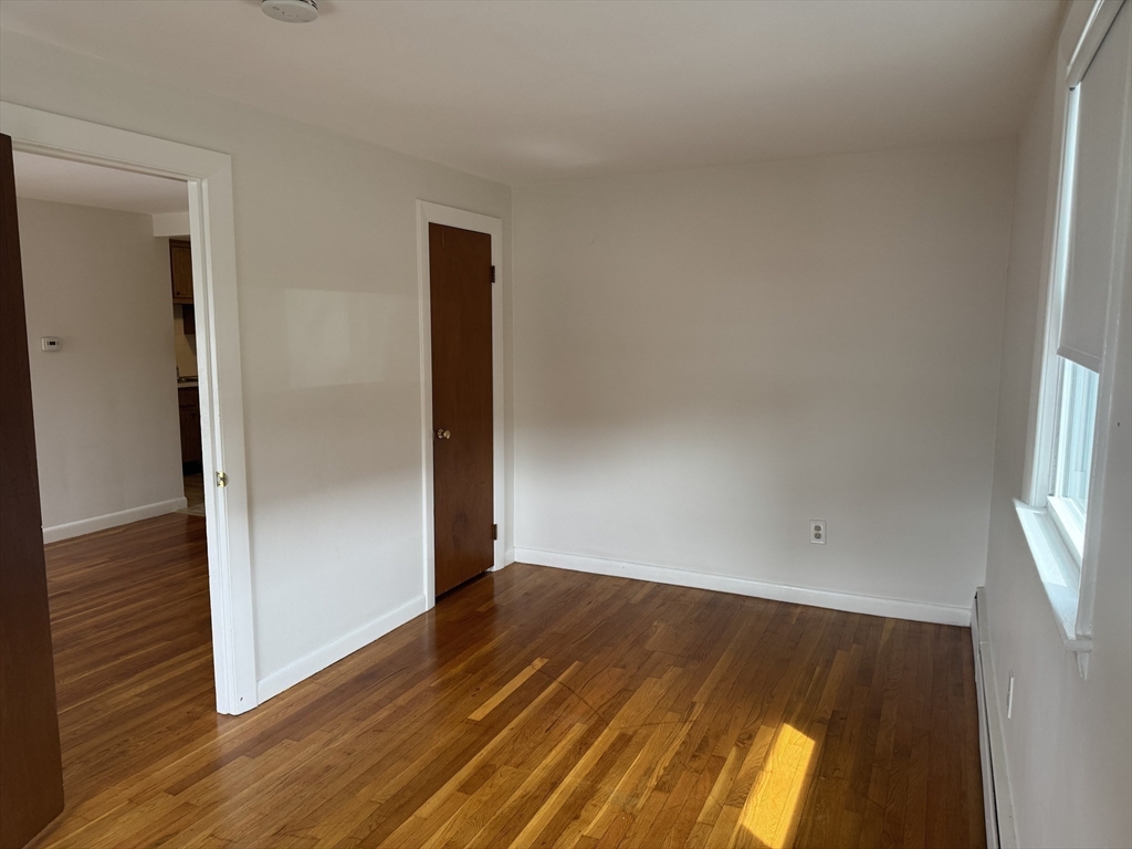 100 Magnolia Avenue, Unit 4 Lynn, MA 01904 - Photo 5 of 19 an empty room with wooden floor and windows