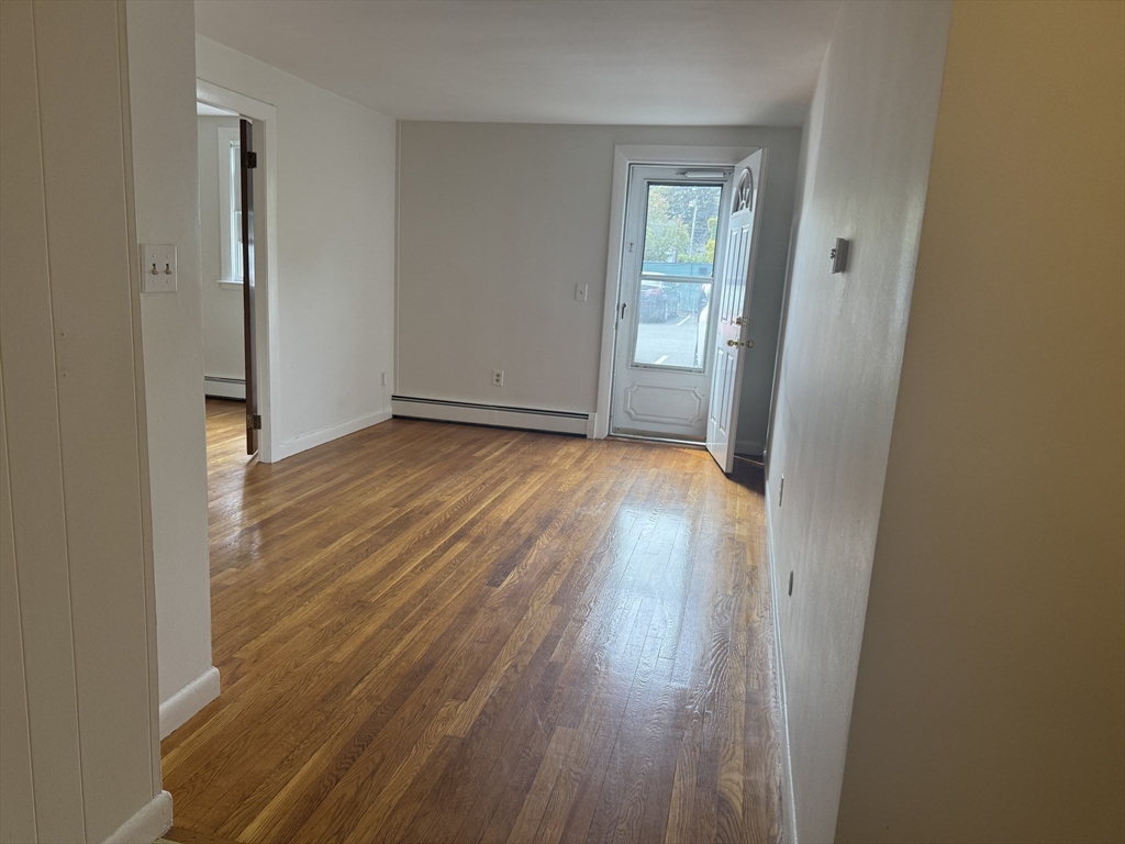 100 Magnolia Avenue, Unit 4 Lynn, MA 01904 - Photo 7 of 19 an empty room with wooden floor and a window