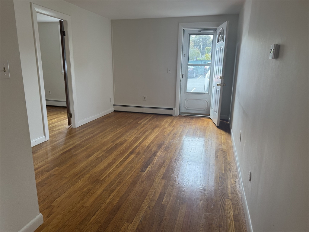 100 Magnolia Avenue, Unit 4 Lynn, MA 01904 - Photo 8 of 19 an empty room with wooden floor and windows