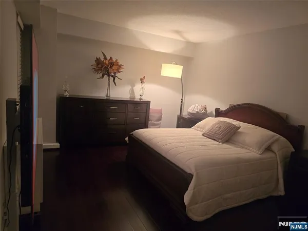 a bedroom with a bed and a potted plant