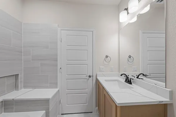 a bathroom with a sink a mirror and a bathtub