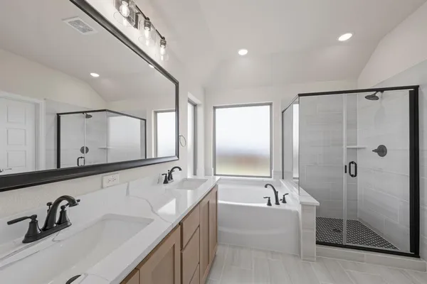 a spacious bathroom with a bathtub shower sink double and mirror