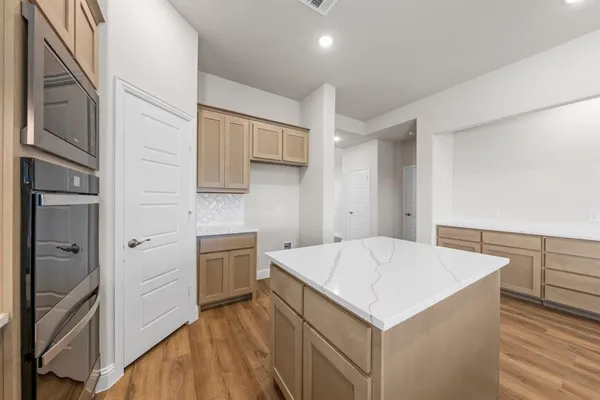 a kitchen that has a cabinets