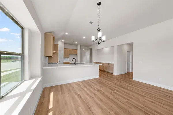 a view of a kitchen with kitchen island a hard wood floor