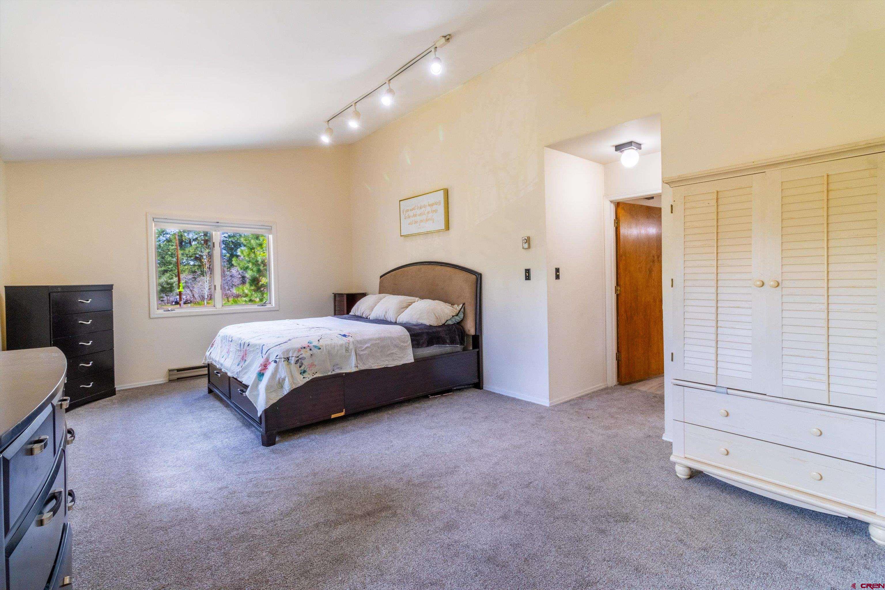67 Pine Ridge Loop Durango, CO 81301 - Photo 15 of 35 a bedroom with a bed and a painting on the wall