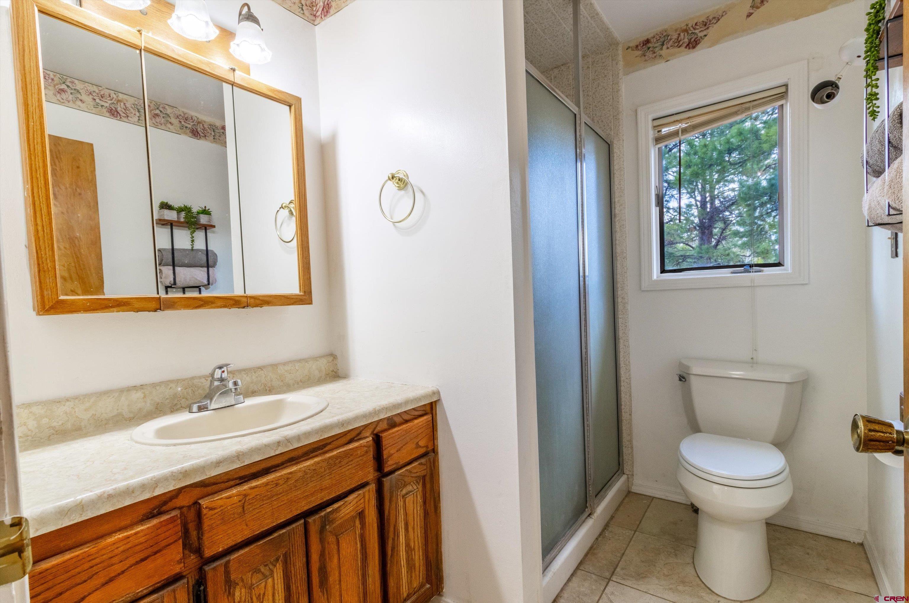 67 Pine Ridge Loop Durango, CO 81301 - Photo 17 of 35 a bathroom with a granite countertop sink a toilet and a mirror