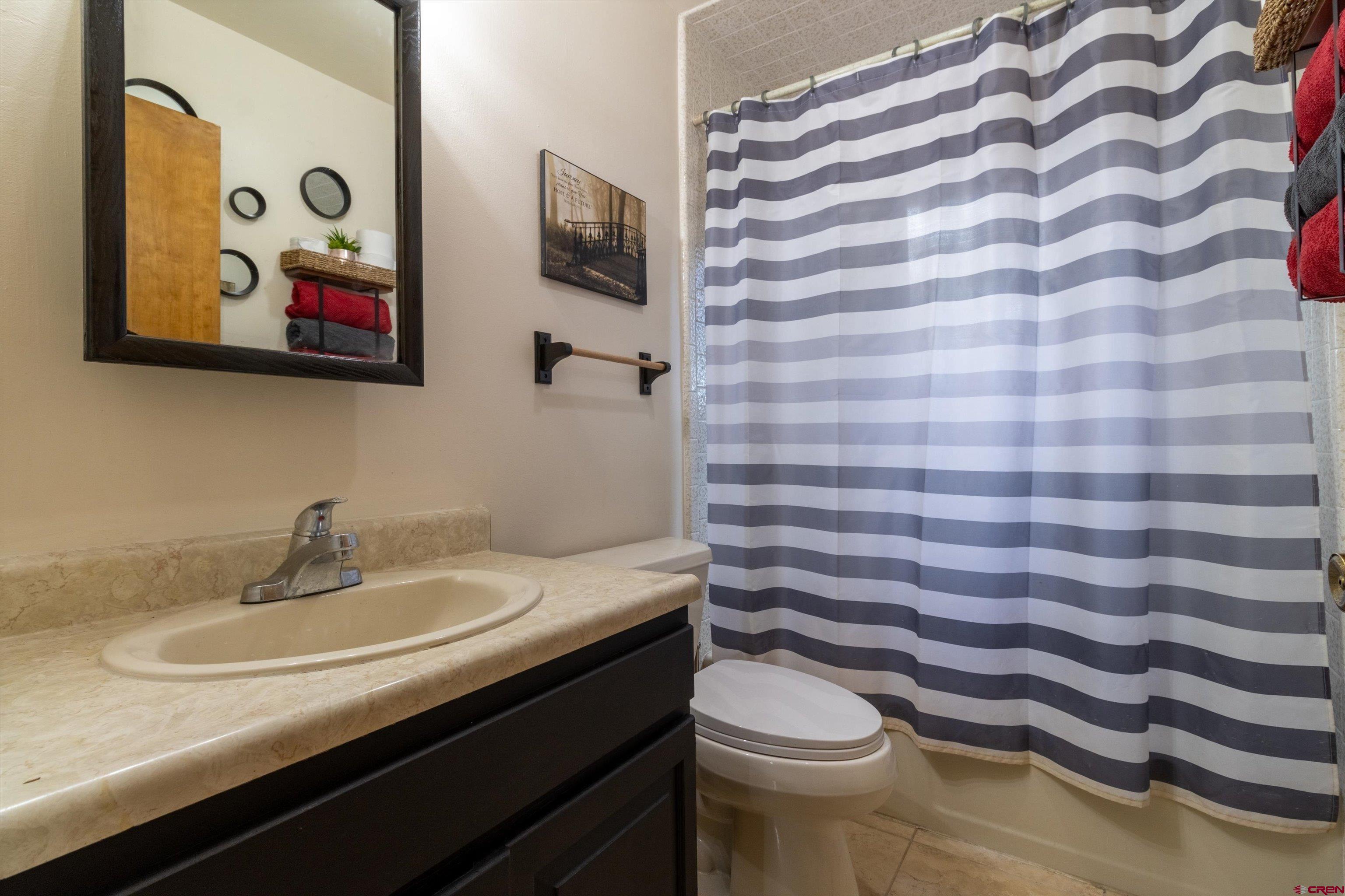 67 Pine Ridge Loop Durango, CO 81301 - Photo 20 of 35 a bathroom with a granite countertop sink and a mirror