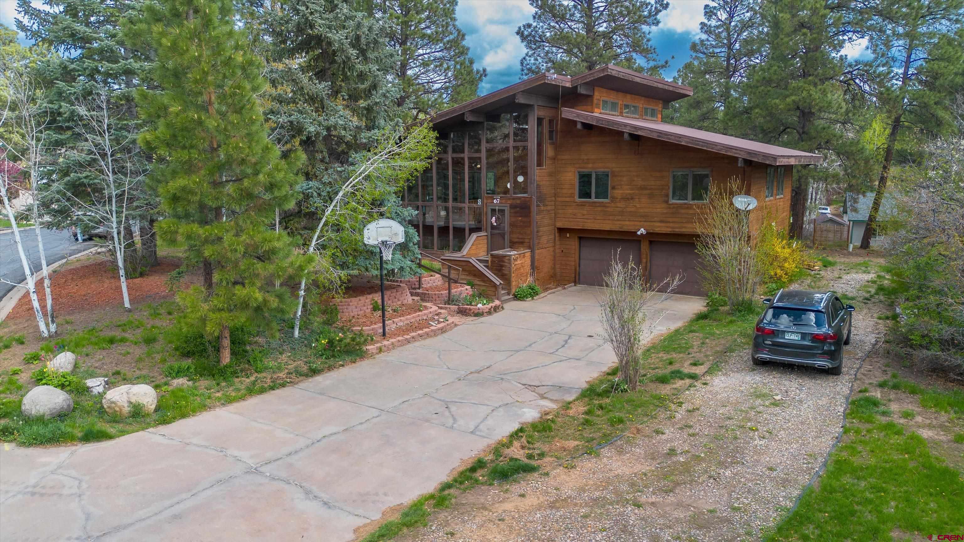 67 Pine Ridge Loop Durango, CO 81301 - Photo 2 of 35 a yellow house with trees in front of it