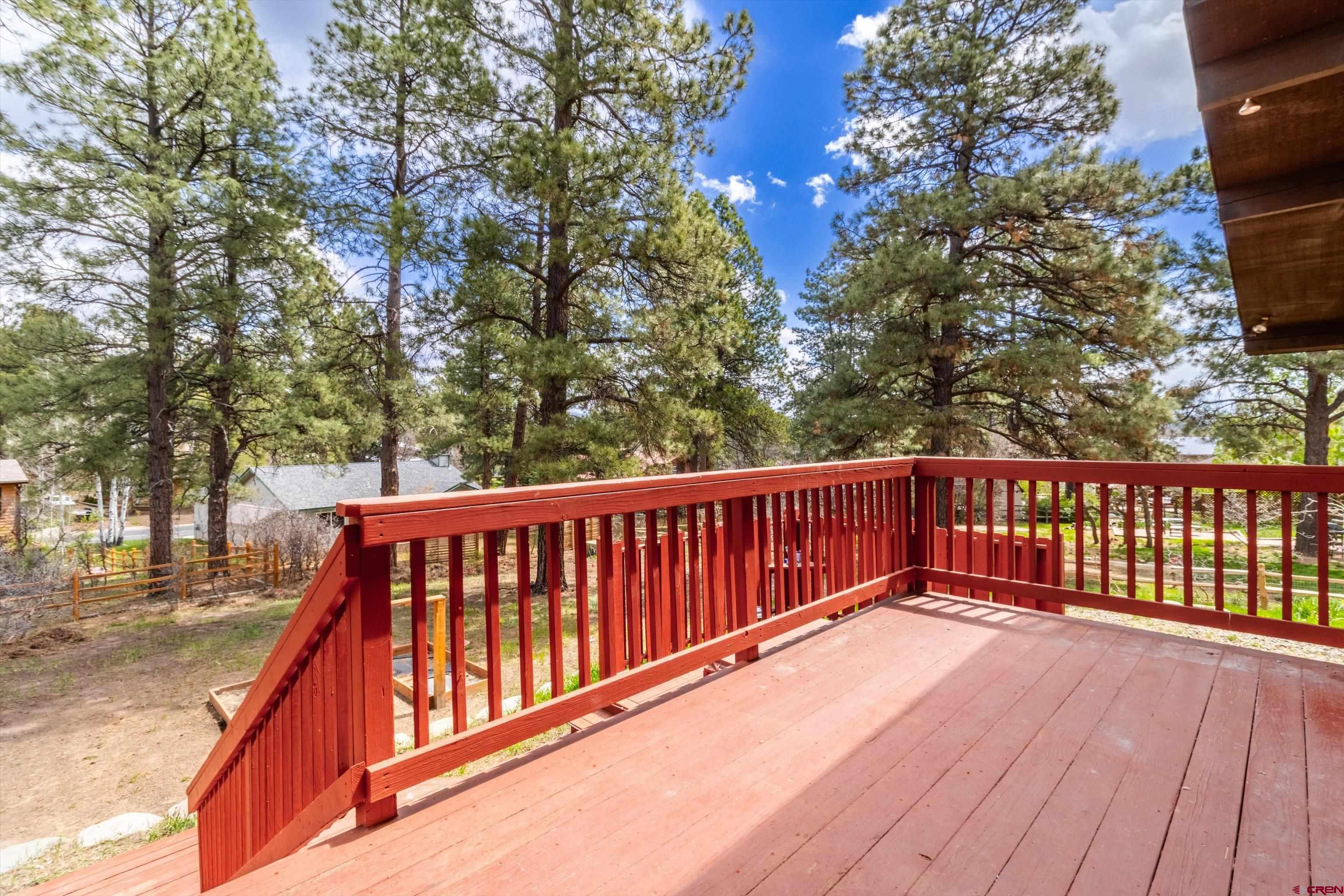 67 Pine Ridge Loop Durango, CO 81301 - Photo 29 of 35 a balcony with wooden floor and fence