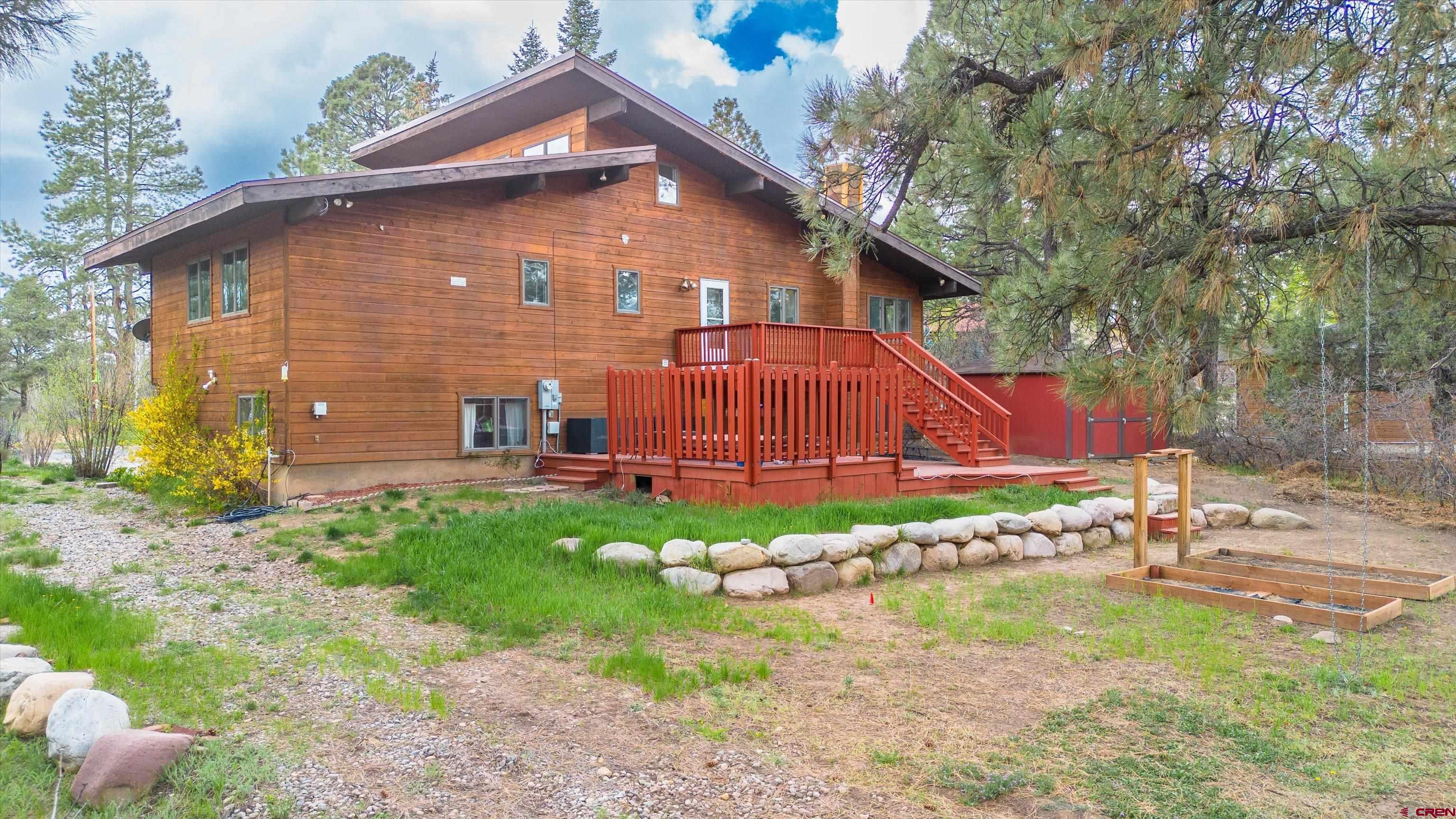 67 Pine Ridge Loop Durango, CO 81301 - Photo 33 of 35 a backyard of a house with table and chairs