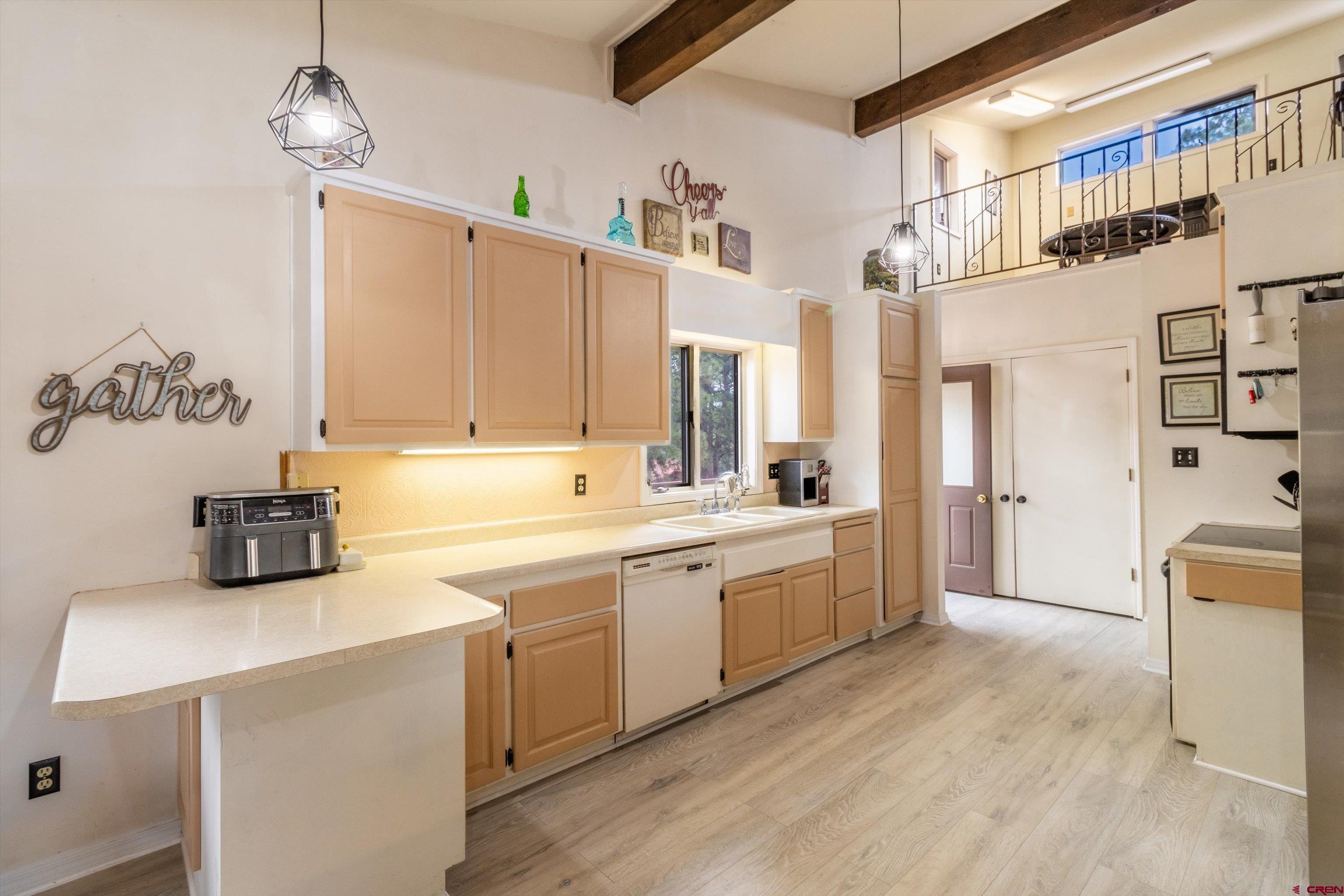 67 Pine Ridge Loop Durango, CO 81301 - Photo 8 of 35 a large white kitchen with sink and cabinets
