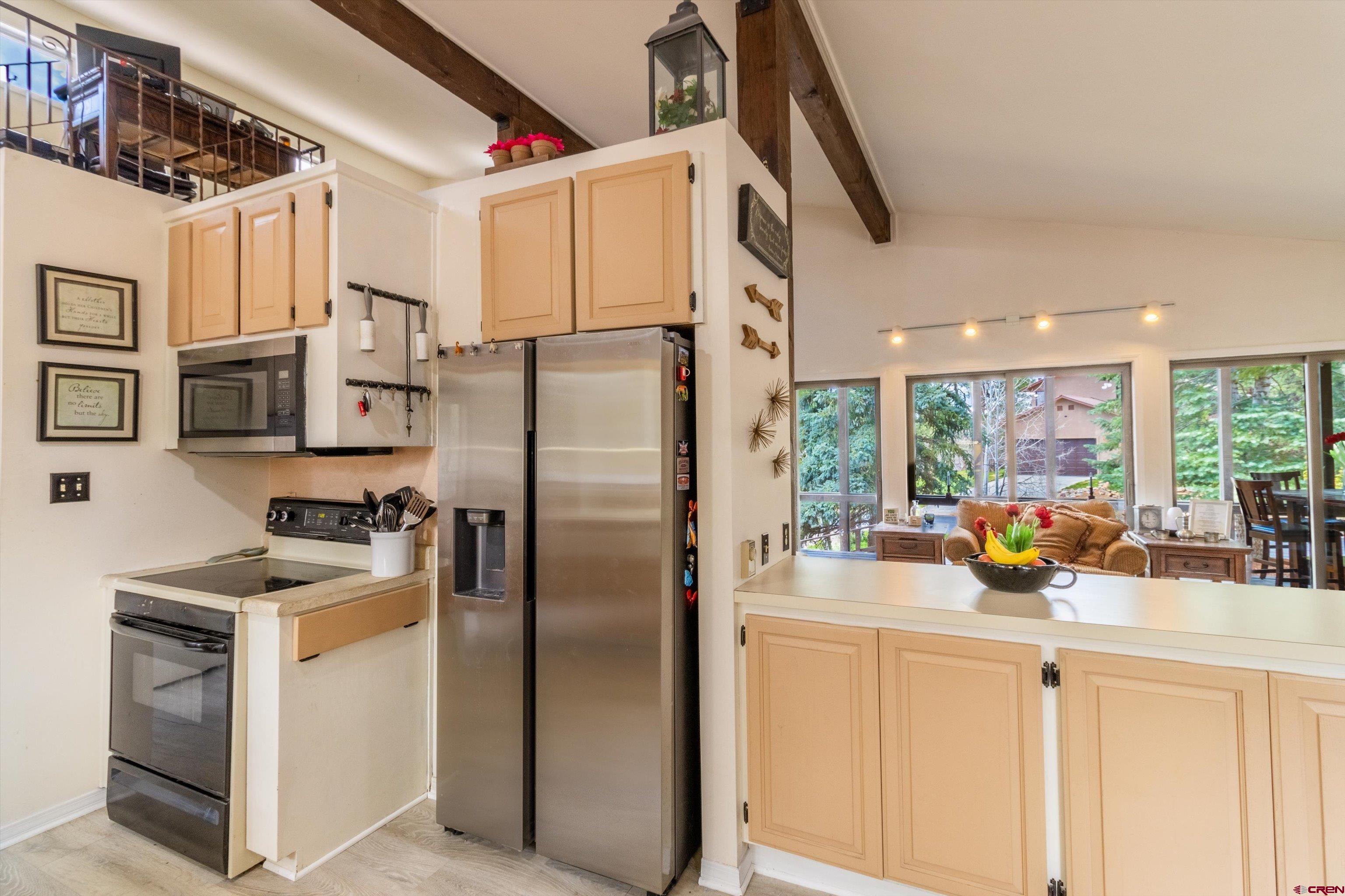 67 Pine Ridge Loop Durango, CO 81301 - Photo 10 of 35 a kitchen with stainless steel appliances a refrigerator sink and cabinets