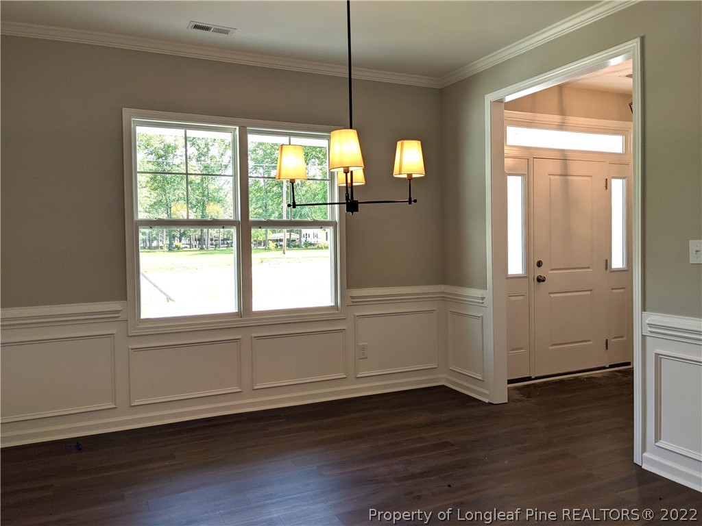 2903 Rockfish Road Raeford, NC 28376 - Photo 11 of 28 a view of empty room with wooden floor and fan