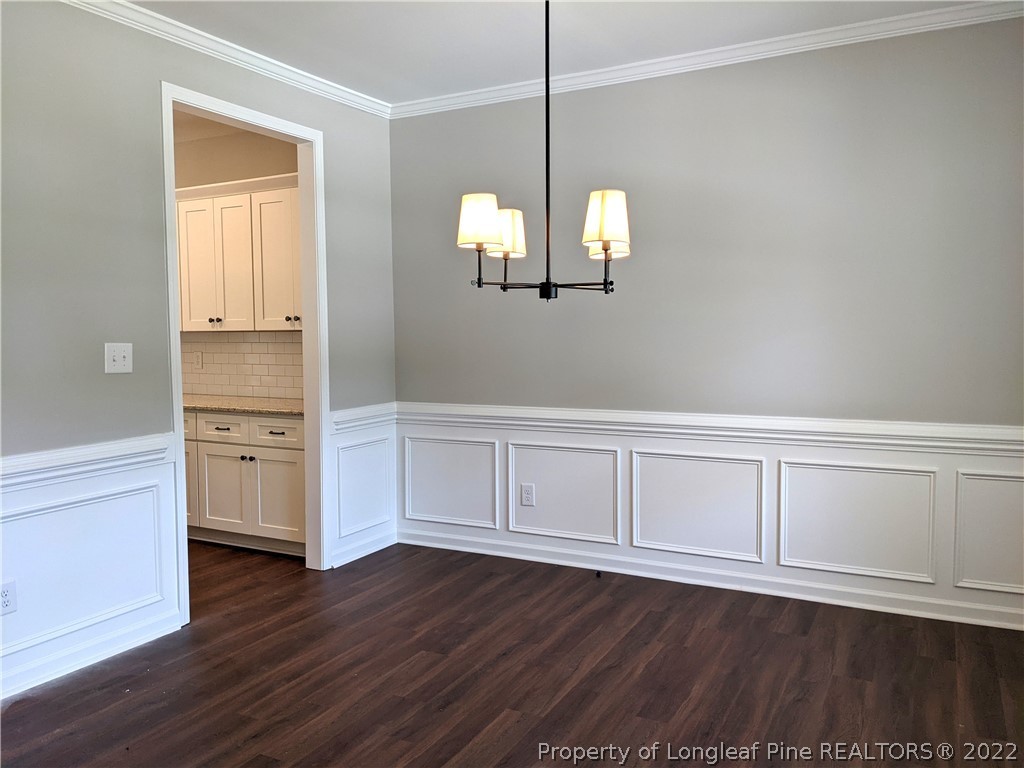 2903 Rockfish Road Raeford, NC 28376 - Photo 12 of 28 a view of a kitchen with wooden floor and cabinets