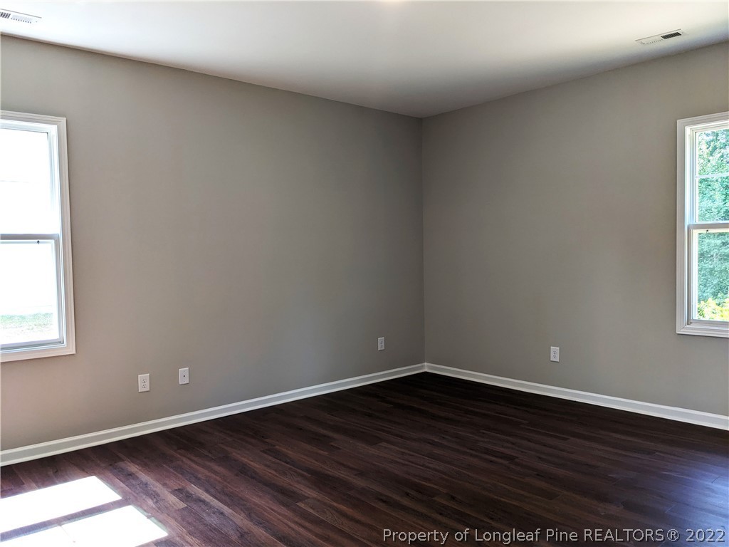 2903 Rockfish Road Raeford, NC 28376 - Photo 14 of 28 a view of an empty room with wooden floor and a window