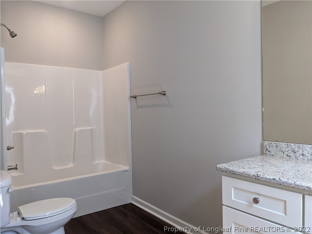 2903 Rockfish Road Raeford, NC 28376 - Photo 15 of 28 a bathroom with a granite countertop sink toilet and shower