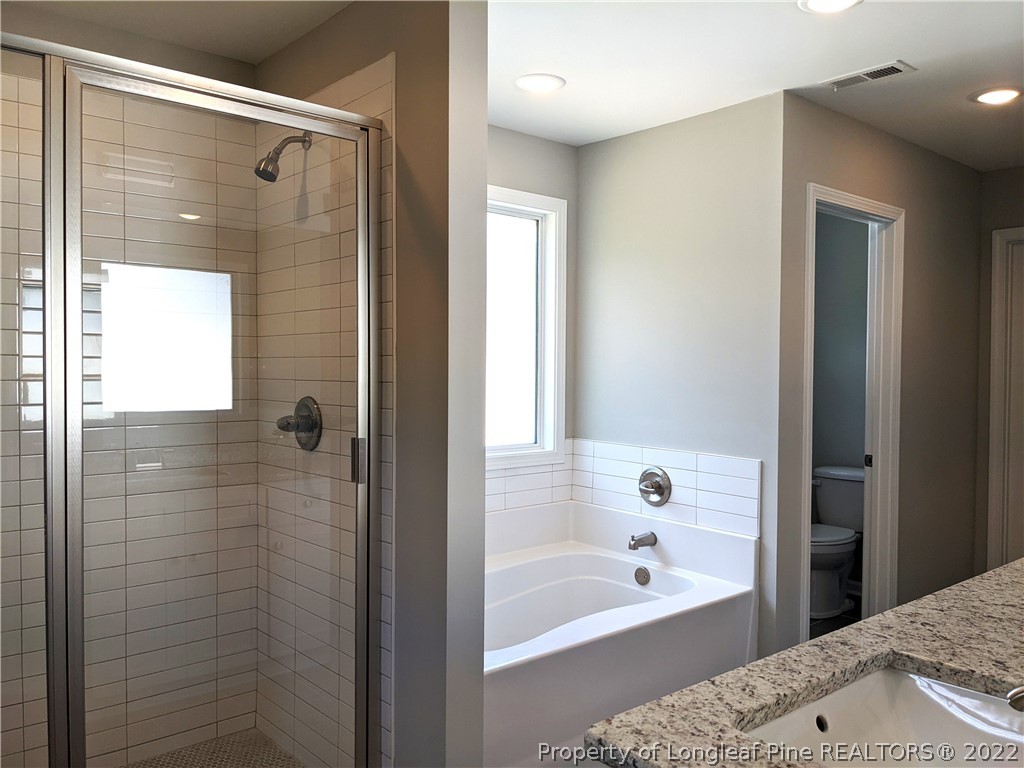 2903 Rockfish Road Raeford, NC 28376 - Photo 23 of 28 a bathroom with a bathtub and shower