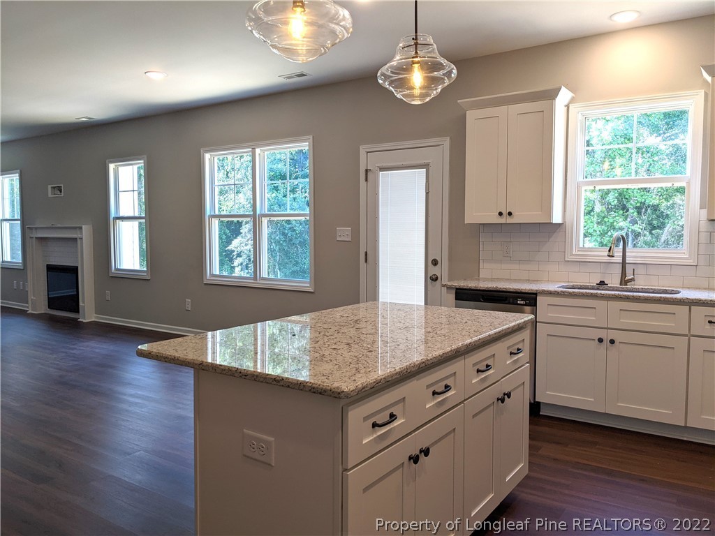 2903 Rockfish Road Raeford, NC 28376 - Photo 10 of 28 a kitchen with sink cabinets and chandelier