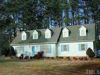 13045 Norwood Road Raleigh, NC 27613 - Photo 1 of 1 a front view of a house with a yard