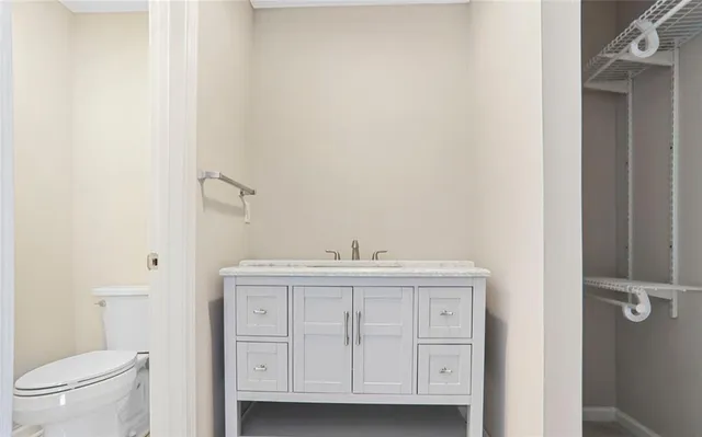 a view of bathroom with a sink toilet and a mirror