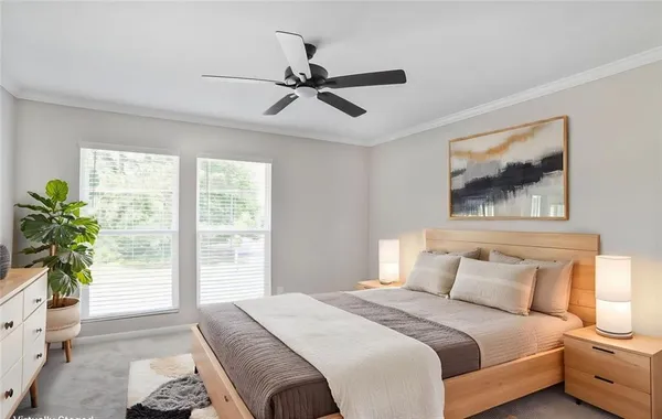 a bedroom with a large bed and a painting on the wall