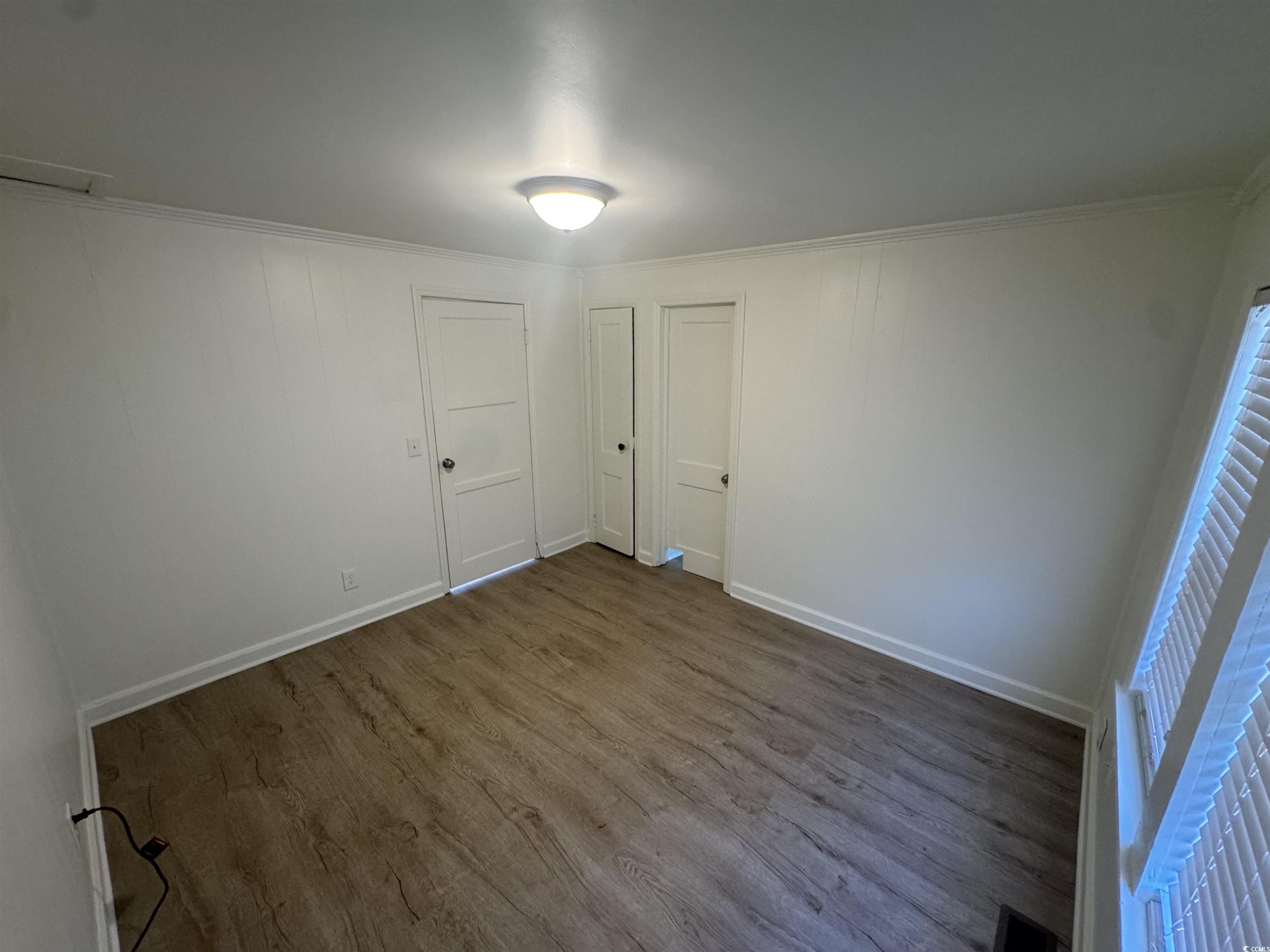 5724 Norton Road Green Sea, SC 29545 - Photo 12 of 20 Empty room with ornamental molding and dark wood finished floors
