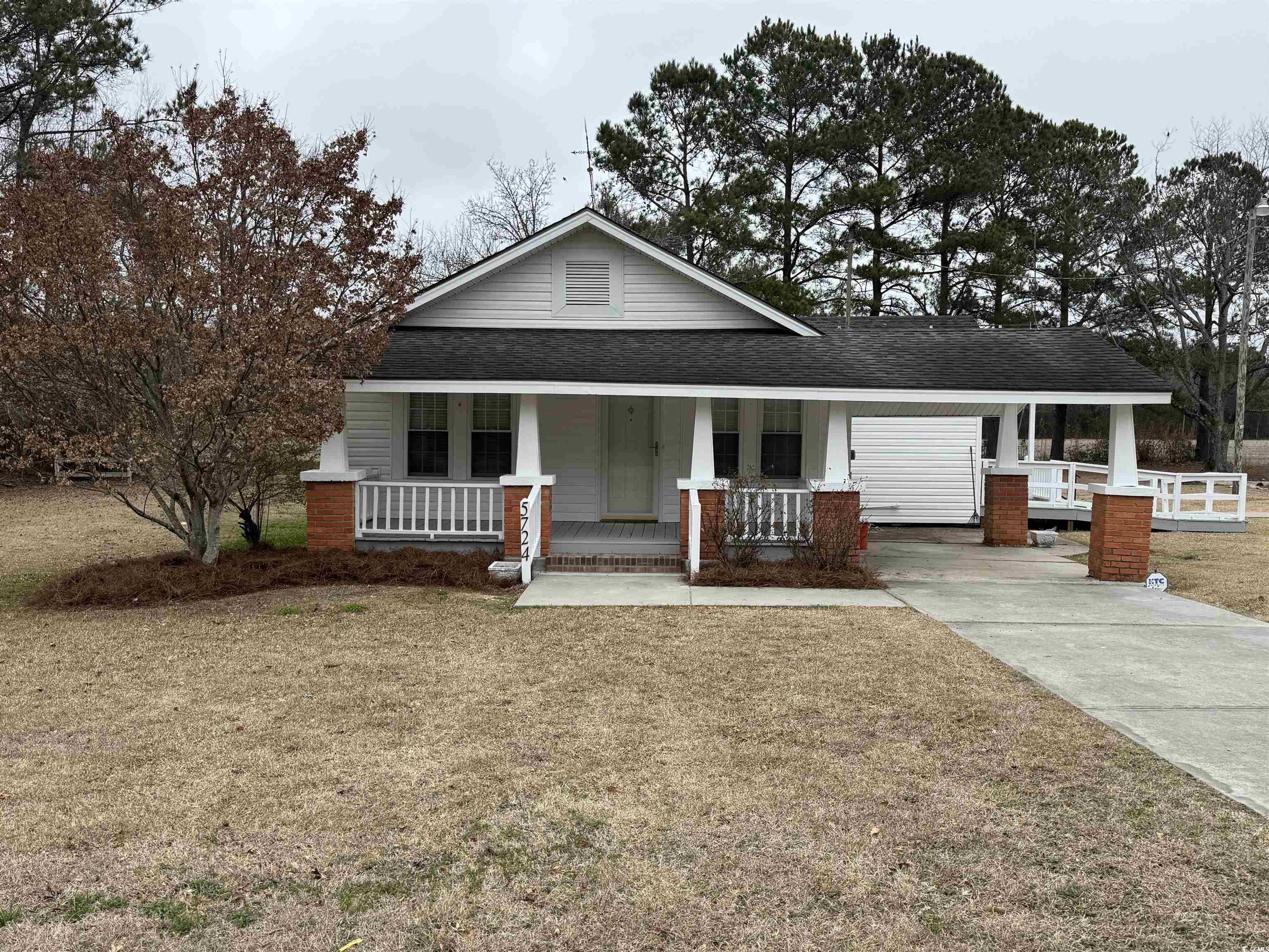 5724 Norton Road Green Sea, SC 29545 - Photo 18 of 20 View of front facade with a porch, a shingled roof, and a front lawn