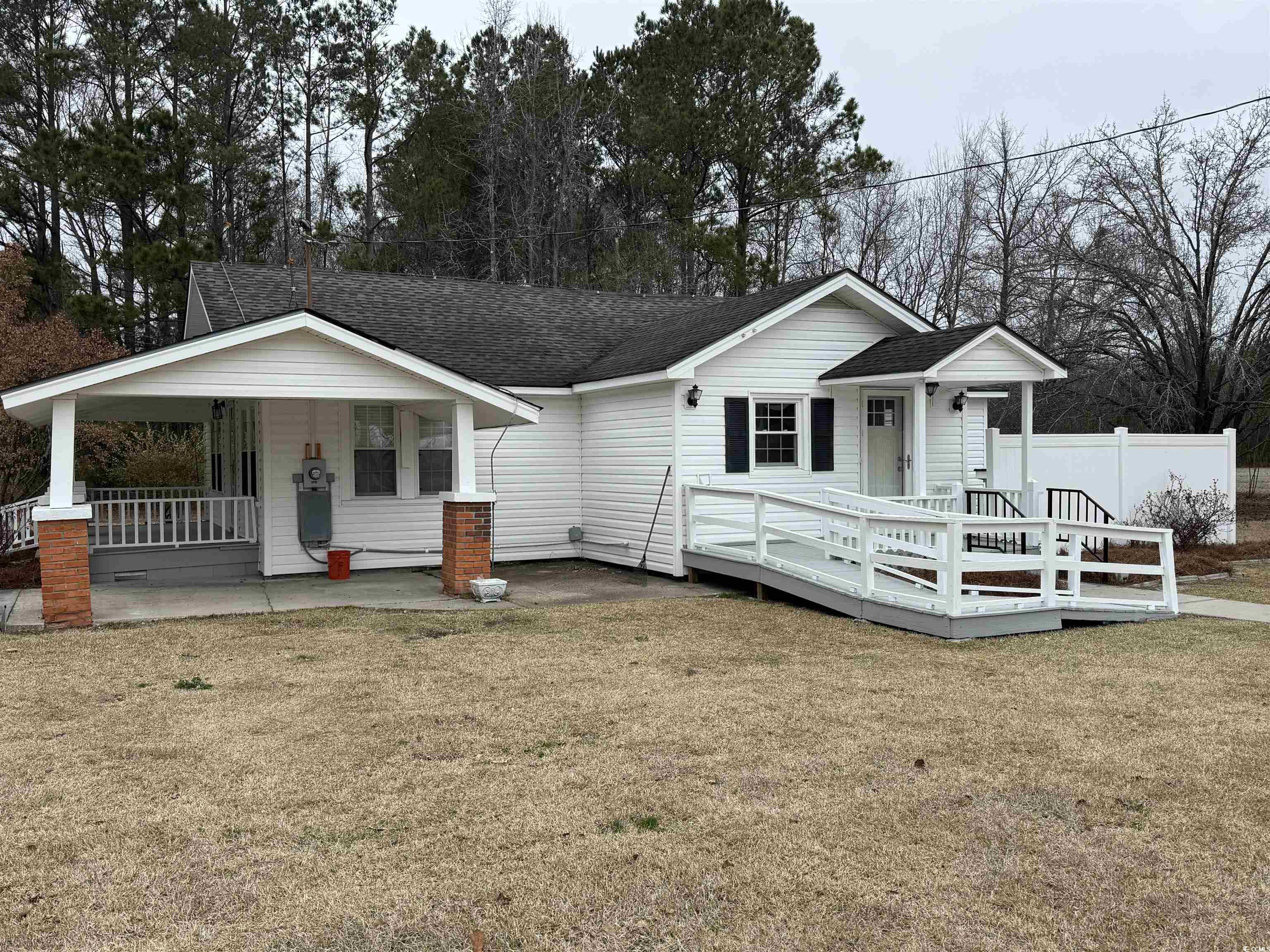 5724 Norton Road Green Sea, SC 29545 - Photo 19 of 20 View of front of home featuring a shingled roof, a porch, and view of scattered trees