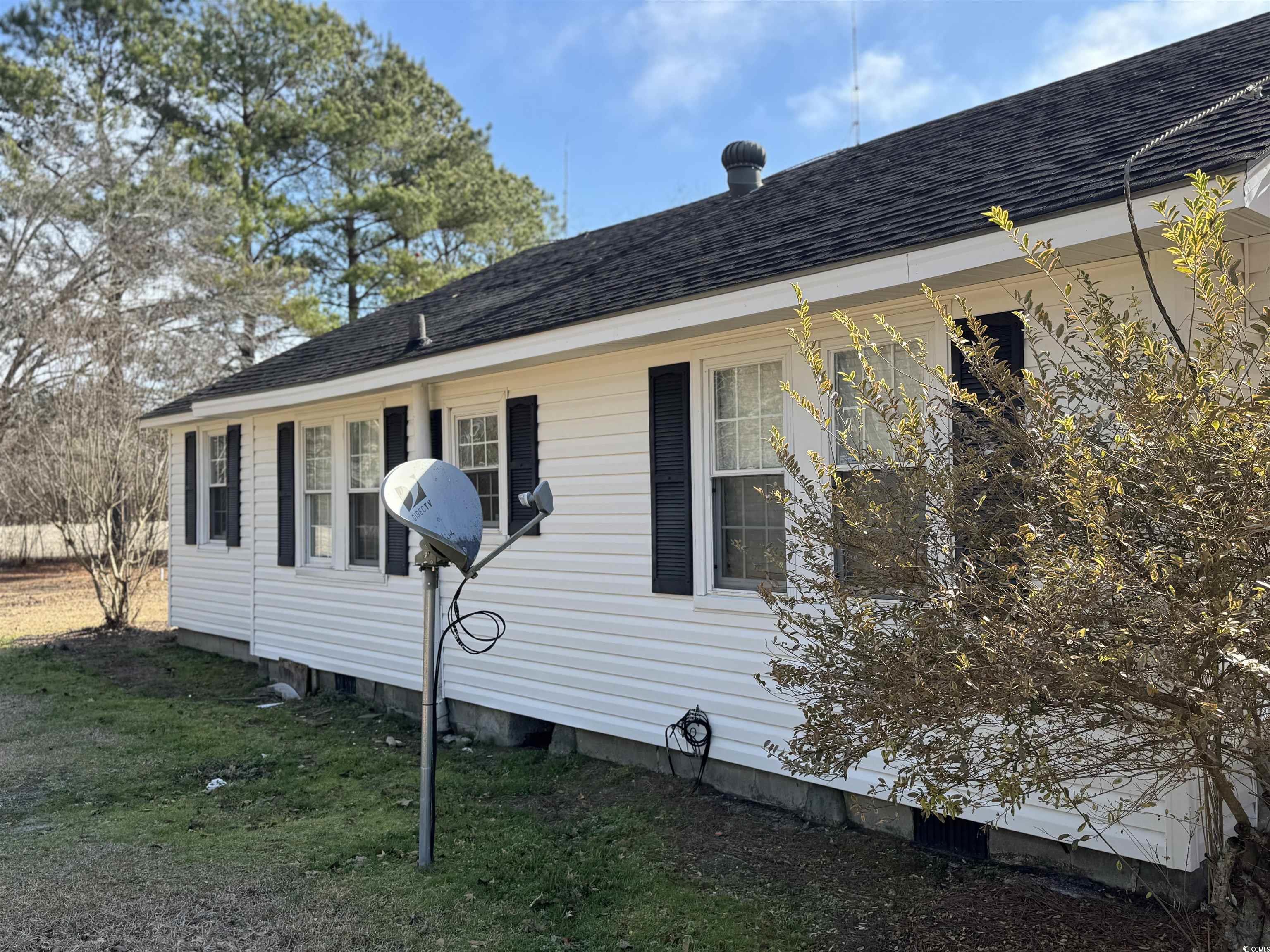5724 Norton Road Green Sea, SC 29545 - Photo 4 of 20 View of side of property featuring roof with shingles and a lawn