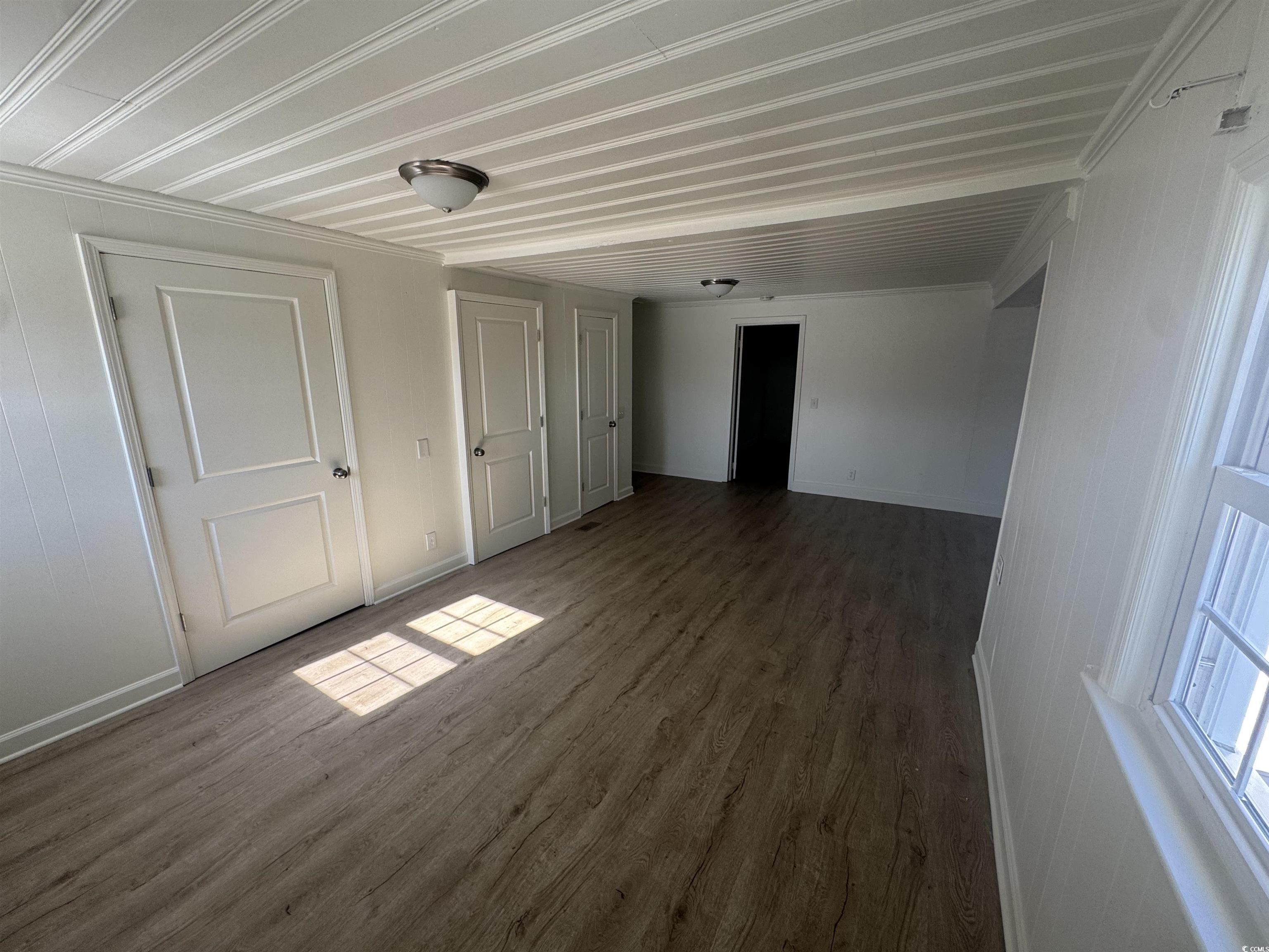 5724 Norton Road Green Sea, SC 29545 - Photo 5 of 20 Unfurnished bedroom with wood finished floors, a closet, and ornamental molding