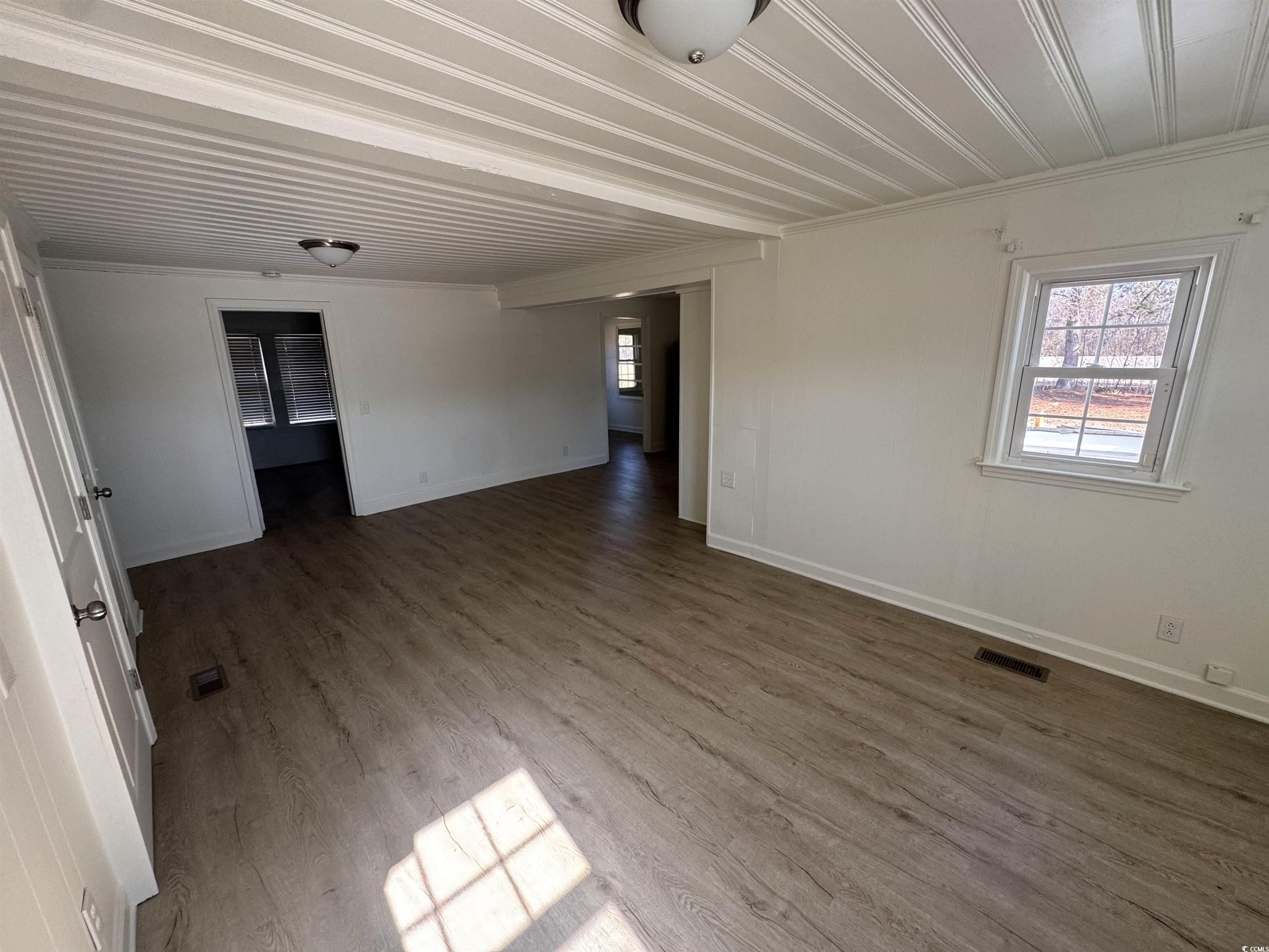 5724 Norton Road Green Sea, SC 29545 - Photo 6 of 20 Unfurnished room featuring wood finished floors and crown molding