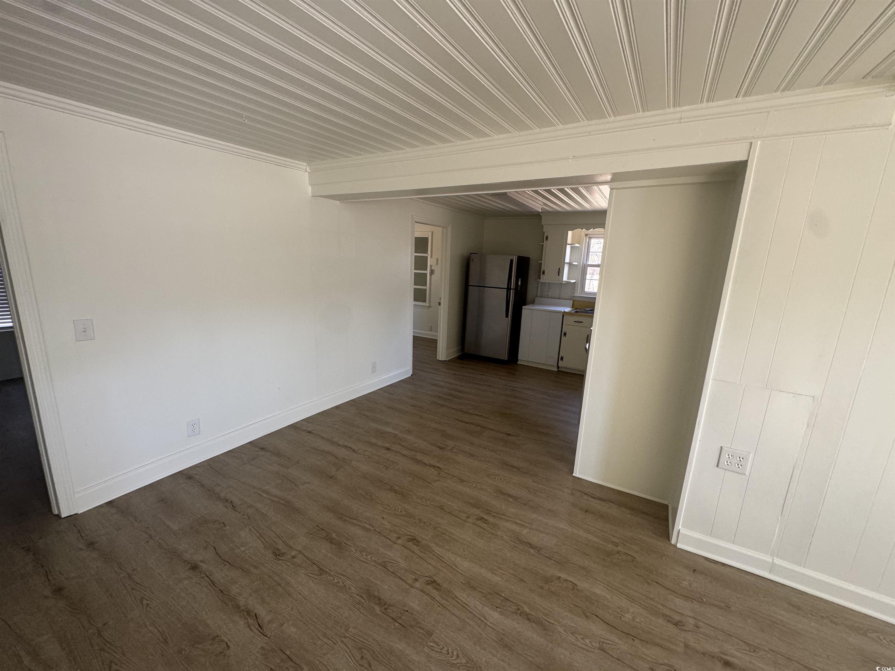5724 Norton Road Green Sea, SC 29545 - Photo 7 of 20 Unfurnished living room featuring dark wood finished floors and baseboards