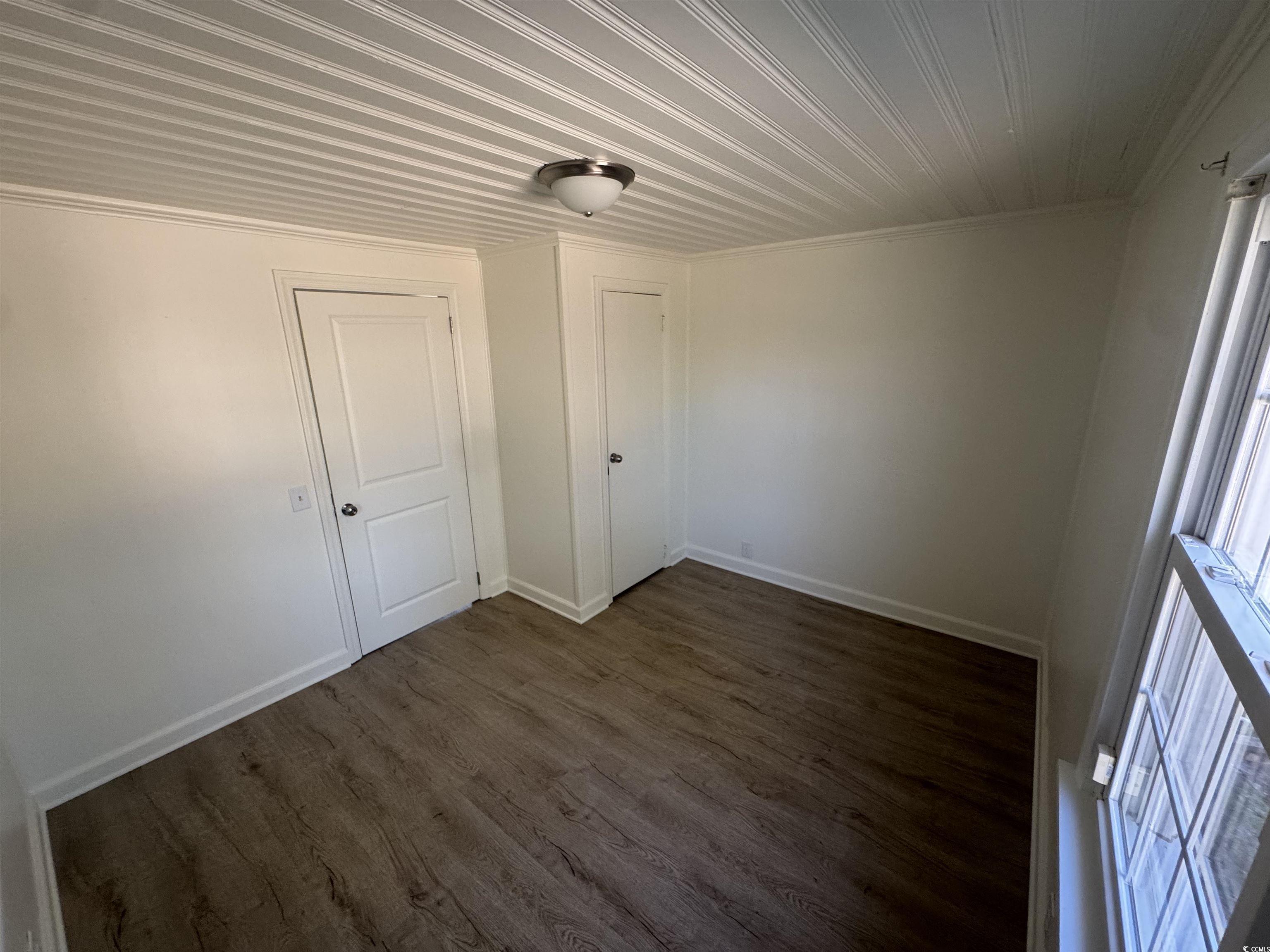 5724 Norton Road Green Sea, SC 29545 - Photo 9 of 20 Unfurnished room with dark wood-style flooring and ornamental molding