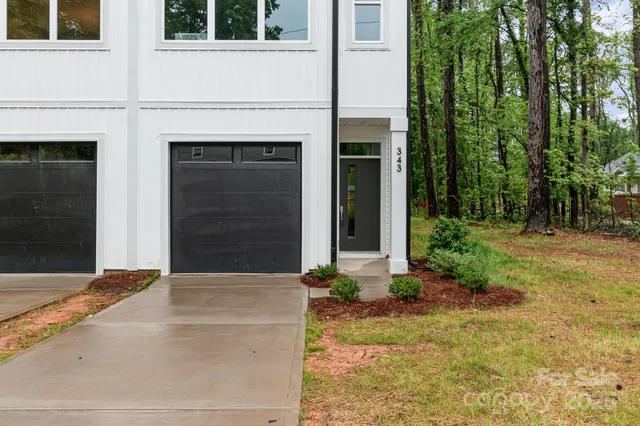 a view of yellow house with front yard