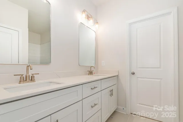 a bathroom with a double vanity sink and a mirror