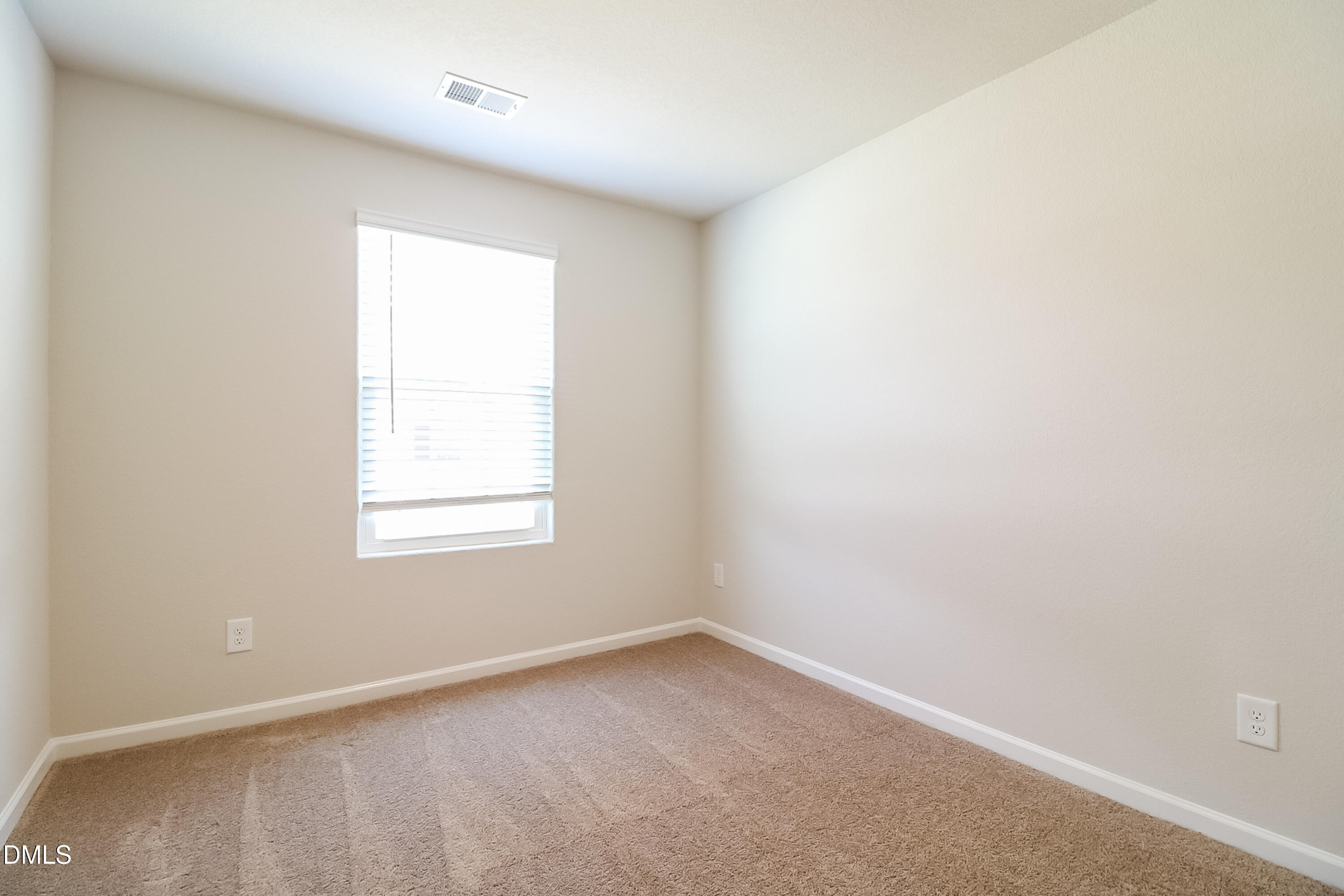 421 Brisk Drive Zebulon, NC 27597 - Photo 11 of 16 an empty room with a window