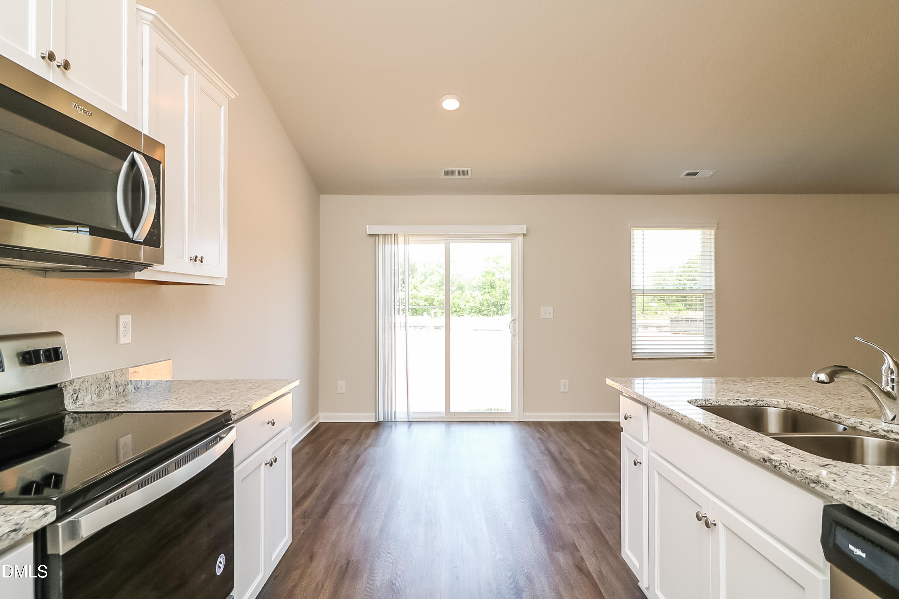 421 Brisk Drive Zebulon, NC 27597 - Photo 6 of 16 a kitchen with a sink wooden floor and stainless steel appliances