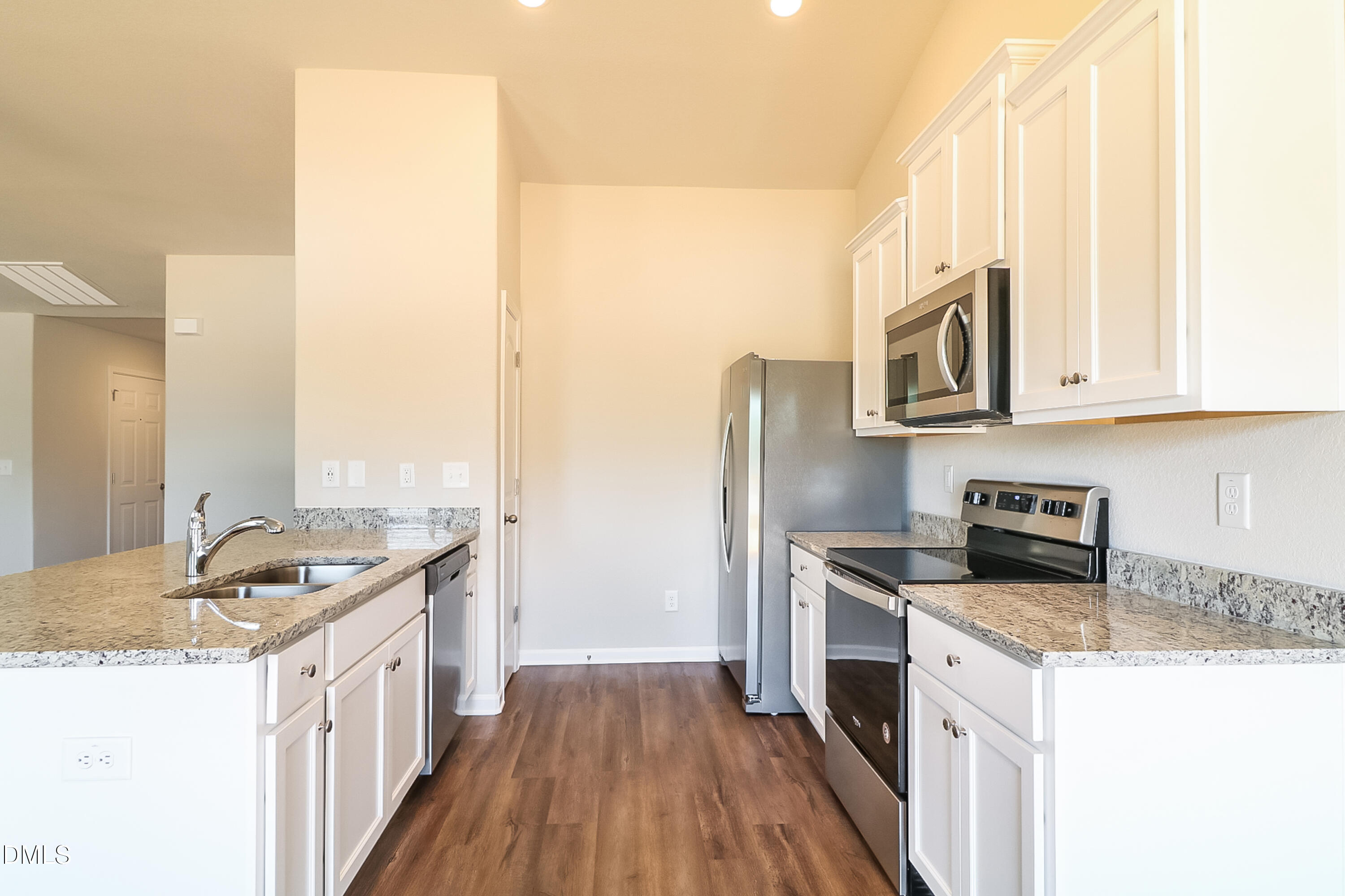 421 Brisk Drive Zebulon, NC 27597 - Photo 7 of 16 a kitchen with stainless steel appliances granite countertop a stove a sink and a microwave
