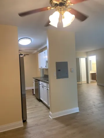 a view of a hallway with a fireplace and a mirror