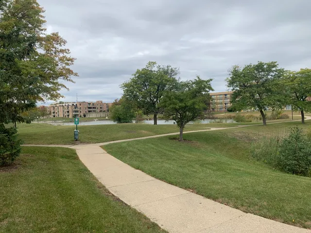 a street sign on a sidewalk next to a road