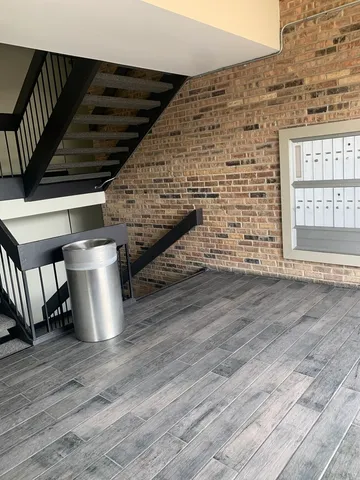 a front view of a house with a garden and lake view