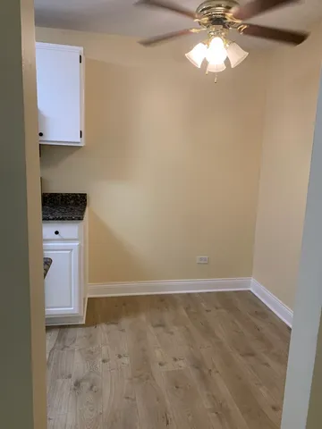a view of kitchen with a sink cabinets and wooden floor