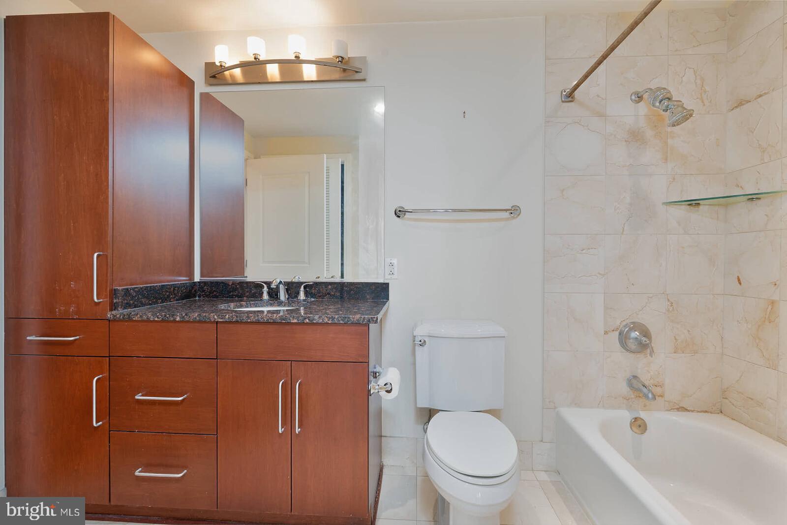 8220 Crestwood Heights Drive, Unit 714 McLean, VA 22102 - Photo 15 of 34 a bathroom with a granite countertop sink a toilet and shower