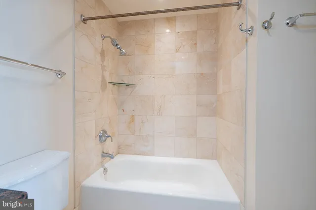 a bathroom with a shower and a bath tub
