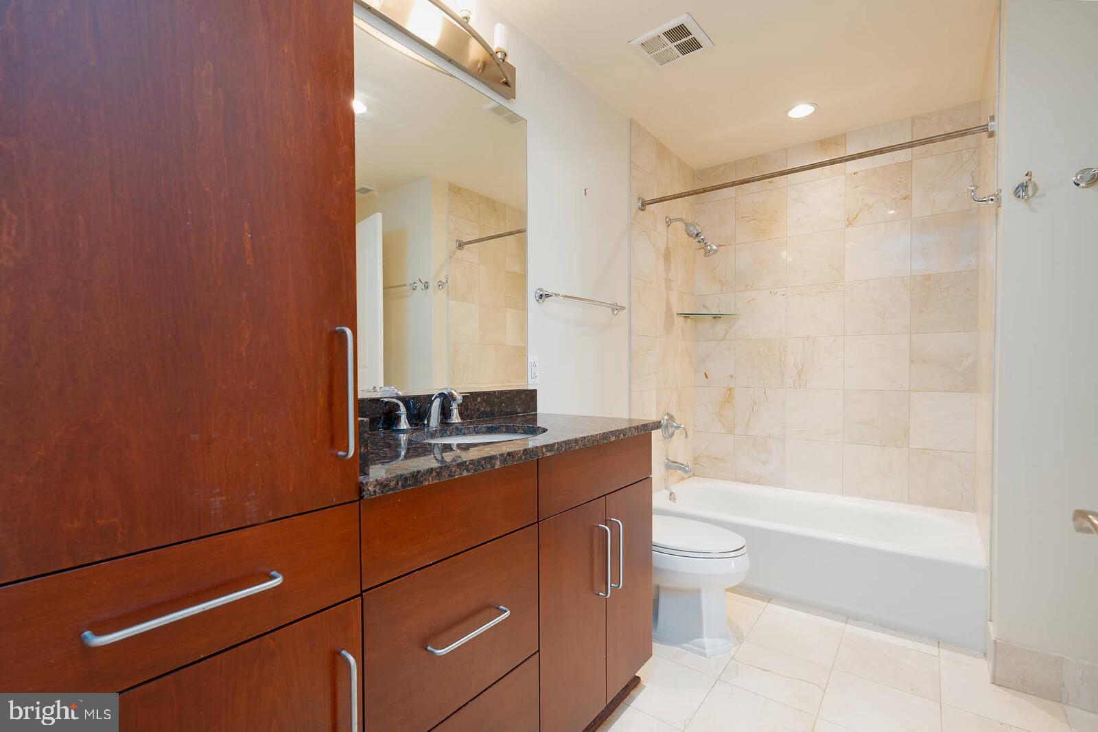 8220 Crestwood Heights Drive, Unit 714 McLean, VA 22102 - Photo 22 of 34 a bathroom with a granite countertop sink a toilet and shower