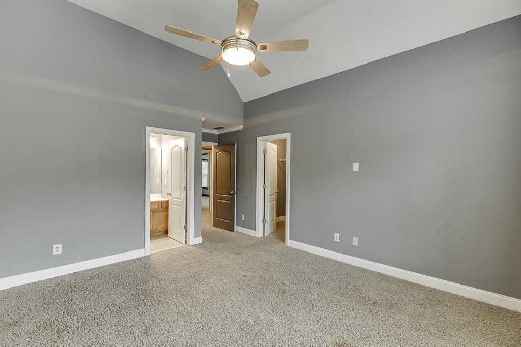 940 Chateau Forest Road Hoschton, GA 30548 - Photo 46 of 87 an empty room with closet and a ceiling fan
