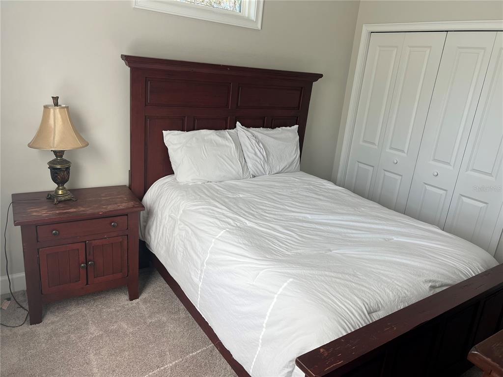 7746 Southeast 70th Avenue Trenton, FL 32693 - Photo 12 of 13 a bedroom with a bed and a table in it